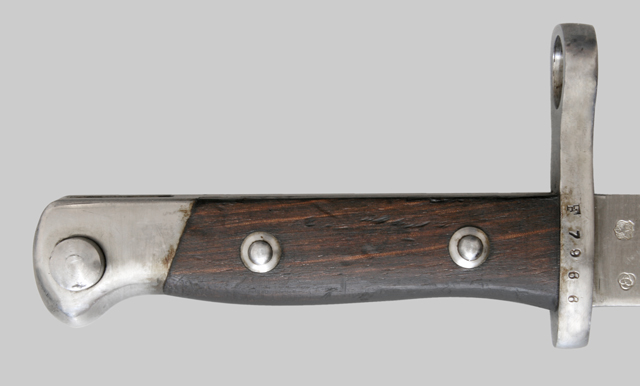 Image of the hilt from a Chilean M1895 bayonet, showing the coil spring press stud.